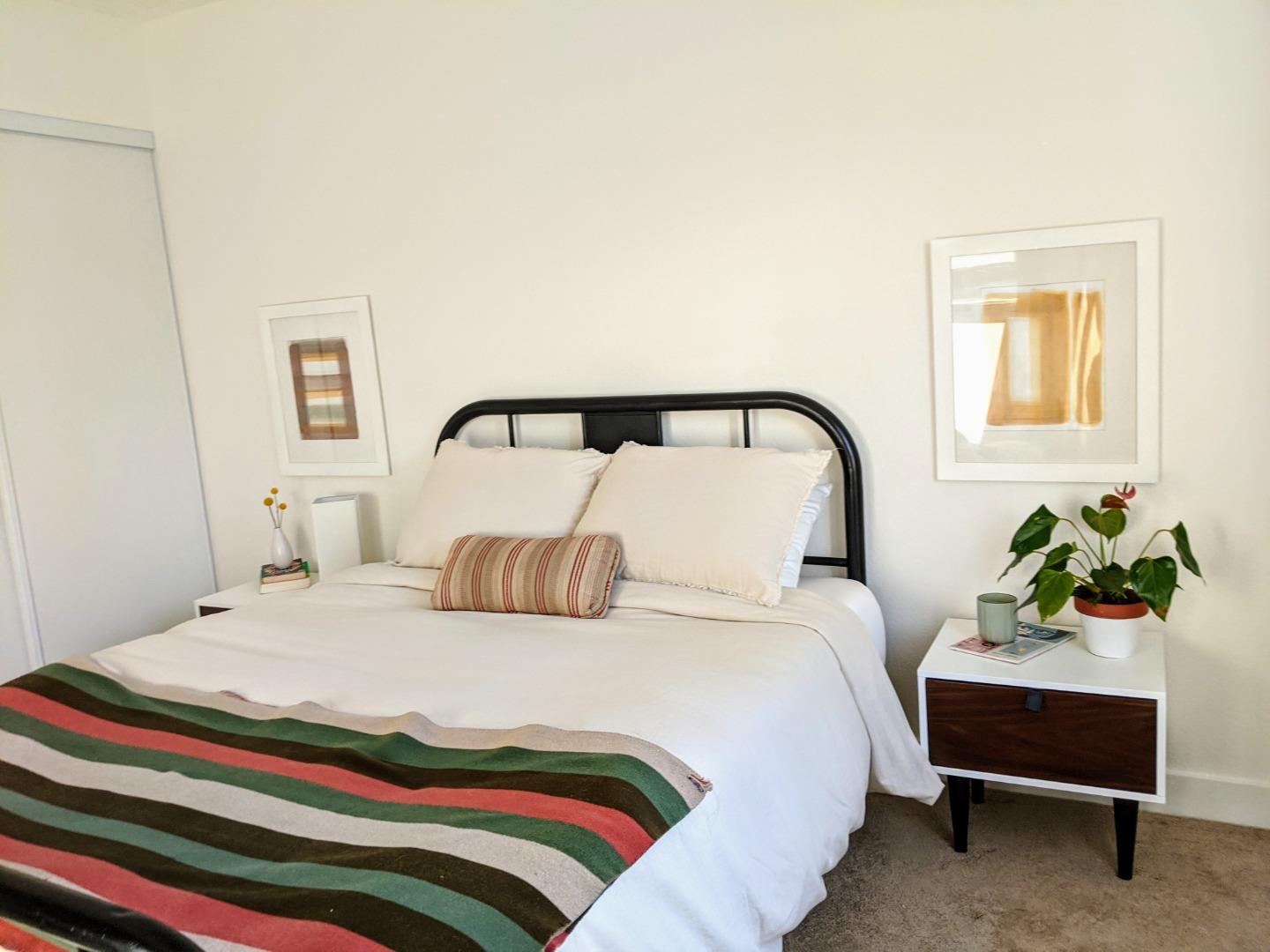 666 Encore Way San Jose, CA 95134 - Photo 16 of 41 a bedroom with a bed and a potted plant