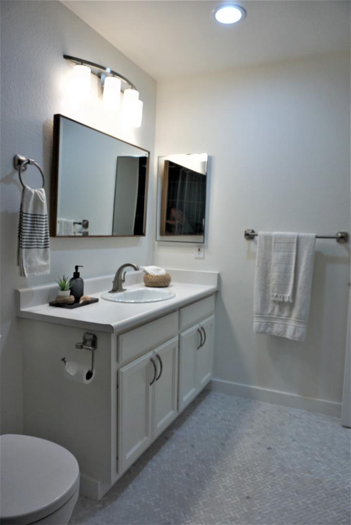 666 Encore Way San Jose, CA 95134 - Photo 27 of 41 a bathroom with a double vanity sink and mirror