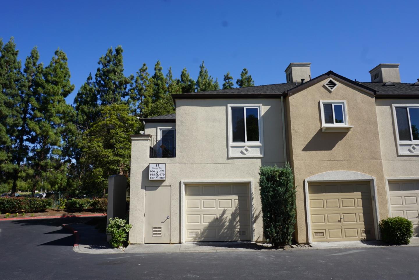 666 Encore Way San Jose, CA 95134 - Photo 35 of 41 a view of a white house with a small yard and garage