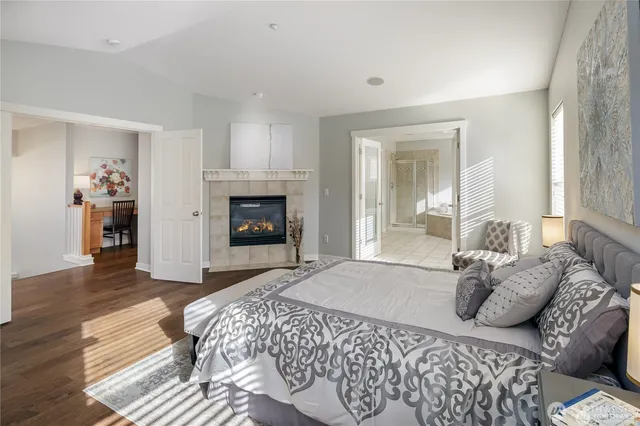 a spacious bedroom with a bed and a fireplace