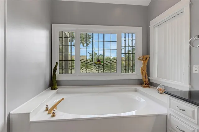 a view of a dining room and livingroom with furniture window and wooden floor