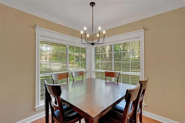 a living room with stainless steel appliances kitchen island granite countertop furniture and a wooden floor