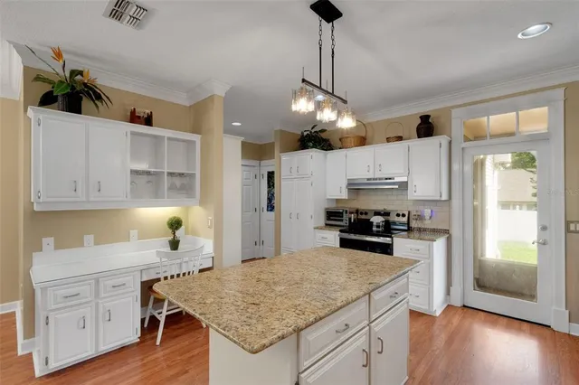 a living room with furniture a fireplace and a large window