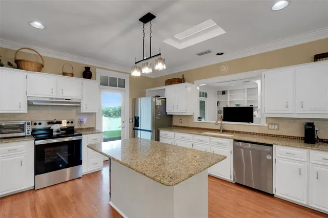 a living room with furniture and a ceiling fan