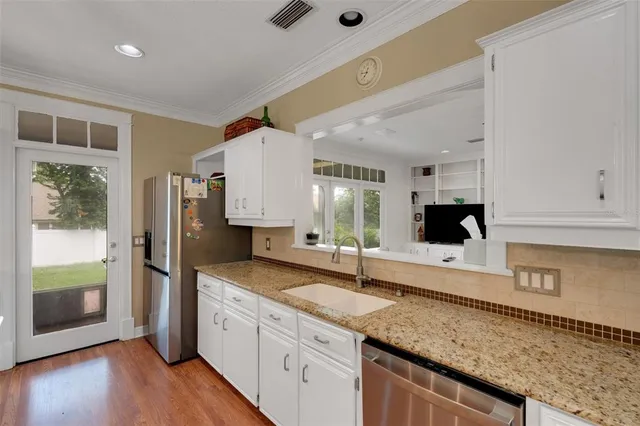 a view of entryway with wooden floor and stairs