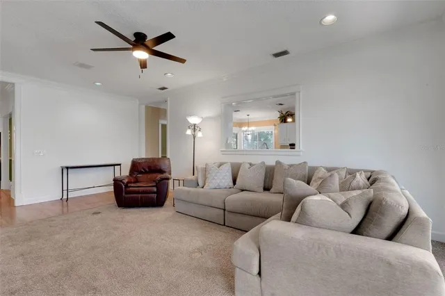 a balcony with wooden floor and trees in the back