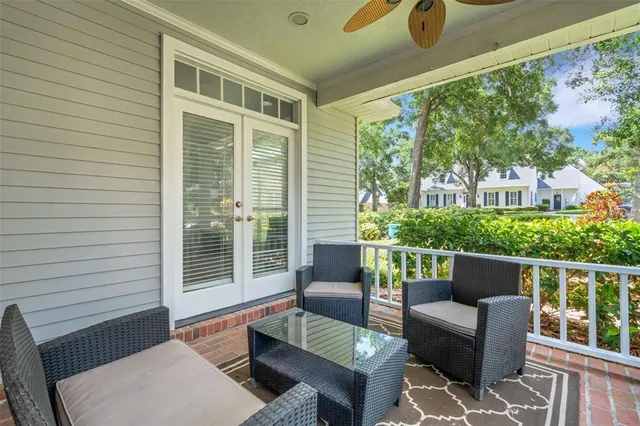 a balcony with furniture and a potted plant