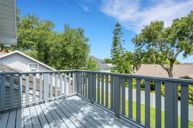 a view of a house with a yard and potted plants