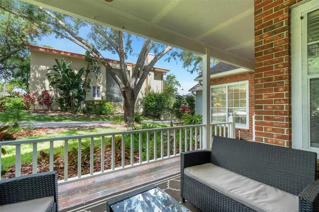a view of a white house with a big yard and large trees