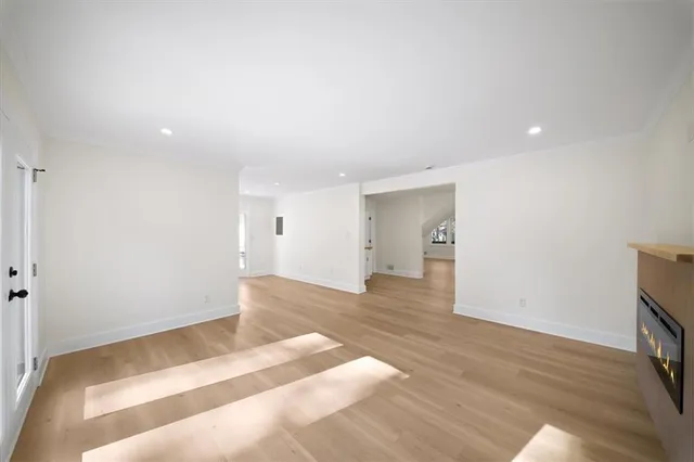 a large kitchen with a lot of counter space and wooden floor