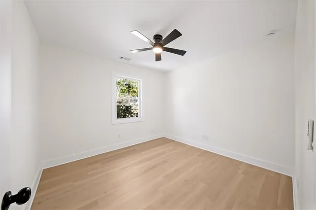 a view of an empty room with wooden floor