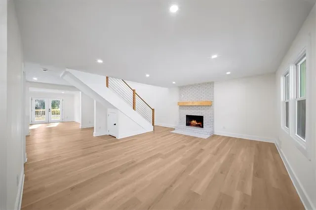 a view of a livingroom with a fireplace and window