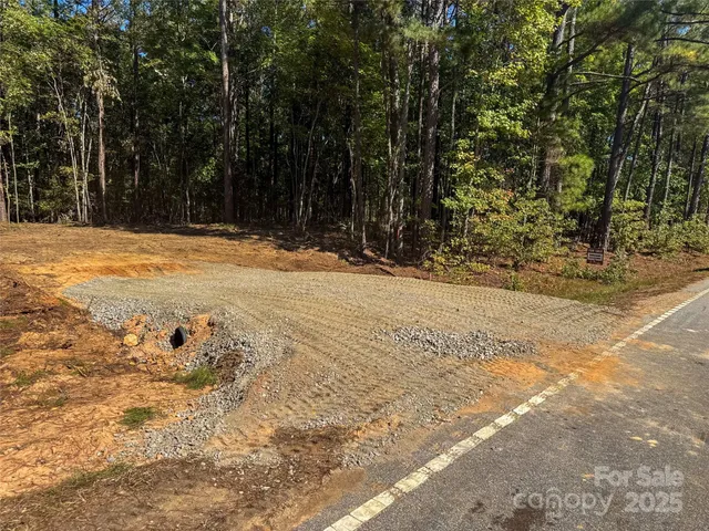 a view of a yard with trees in front of it