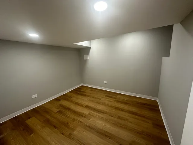 an empty room with wooden floor