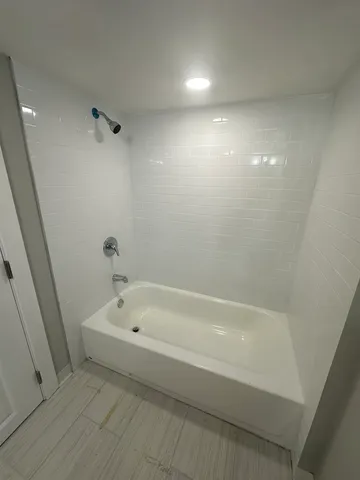 a white bath tub sitting in a bathroom