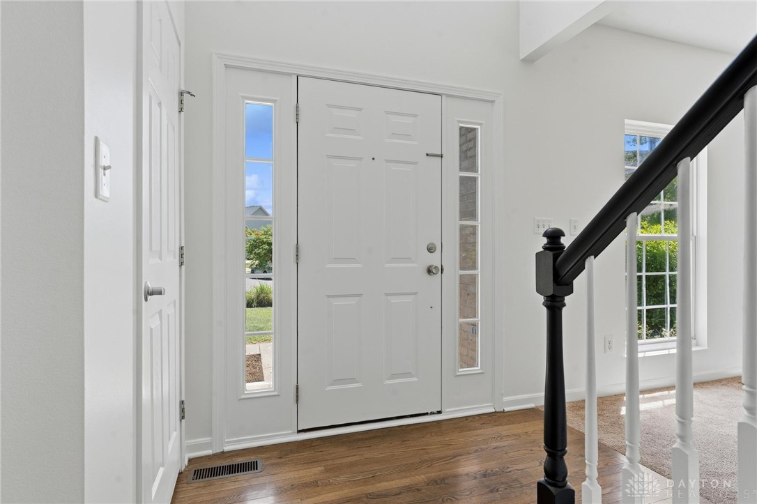 70 Martin Lane Springboro, OH 45066 - Photo 6 of 69 This bright entry offers a warm welcome with rich hardwood flooring and a classic staircase.