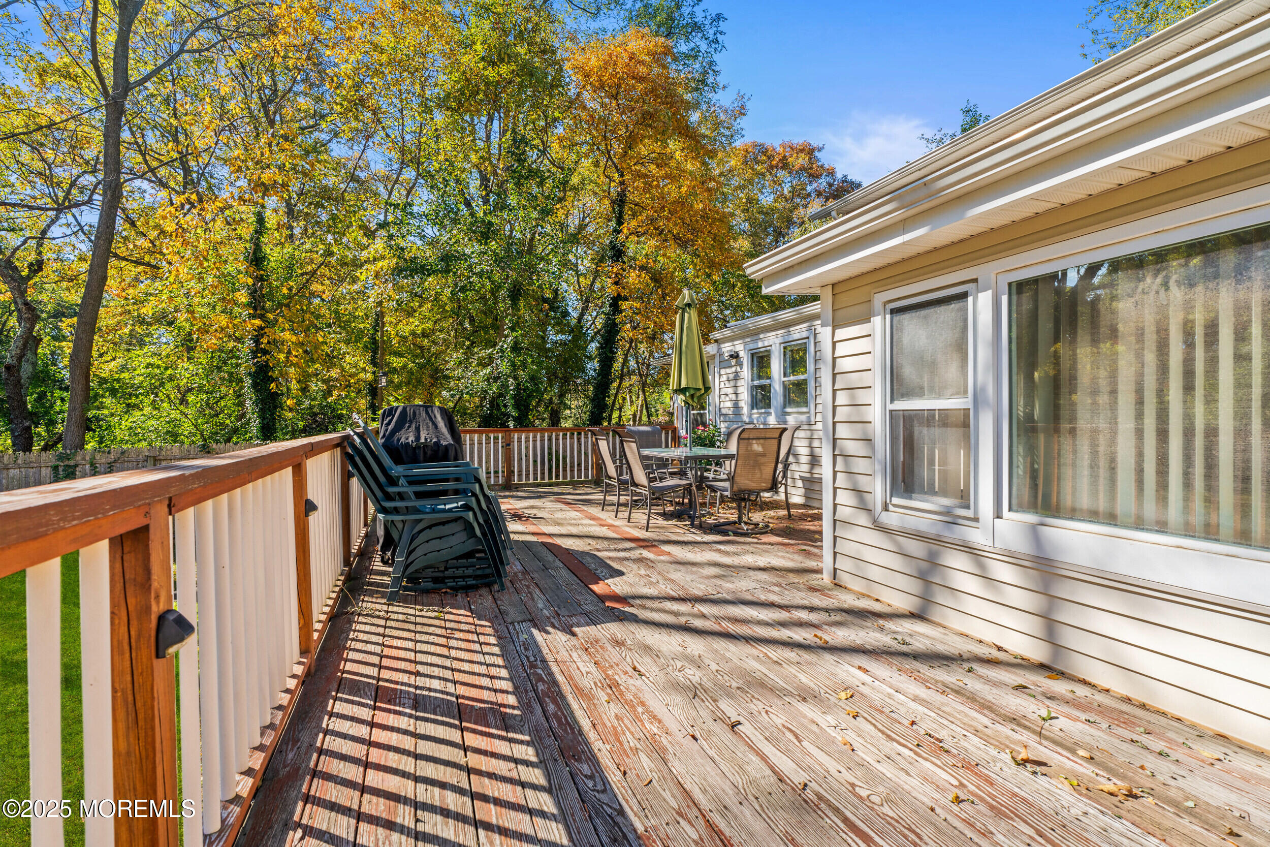 3020 Shafto Road Tinton Falls, NJ 07753 - Photo 16 of 42 a view of a balcony with chairs and wooden floor