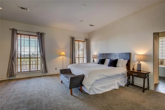 a spacious bedroom with a bed and a window