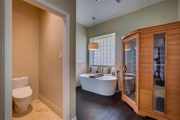 a bathroom with a toilet a sink and shower