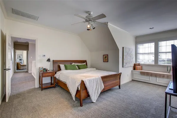 a spacious bedroom with a bed and a large window