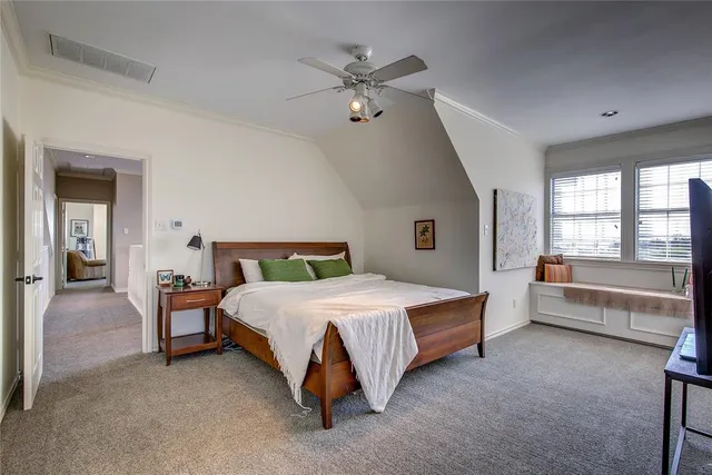 a spacious bedroom with a bed and a large window