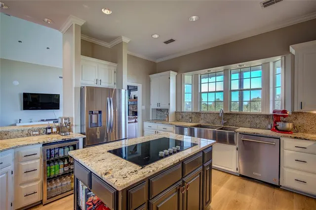 a kitchen that has a sink and a stove in it
