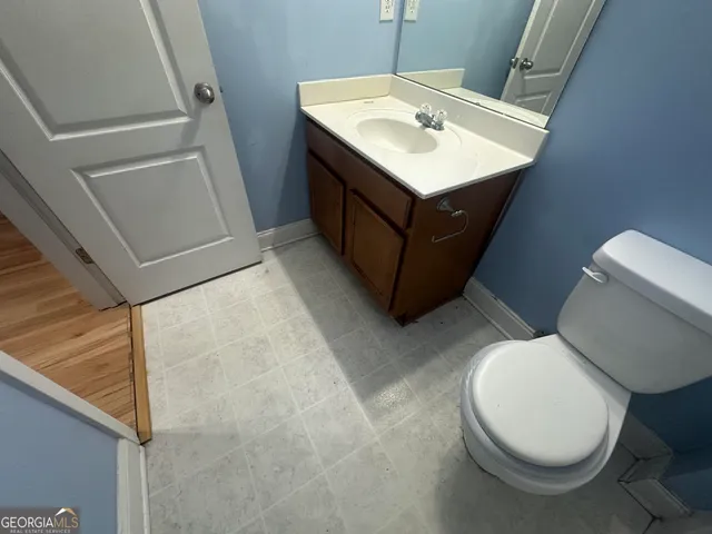 a view of empty room with window and wooden floor