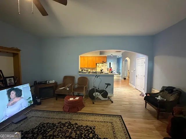 a living room with furniture and a flat screen tv