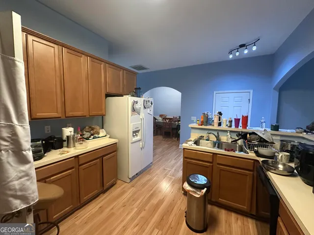 a kitchen with a sink stove and cabinets