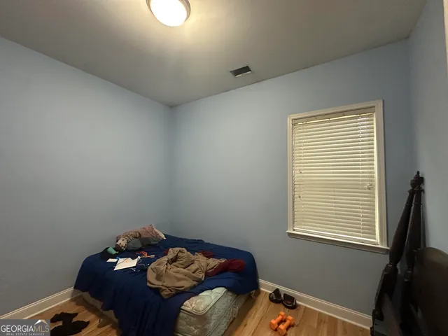 a bed sitting in a bedroom next to a window