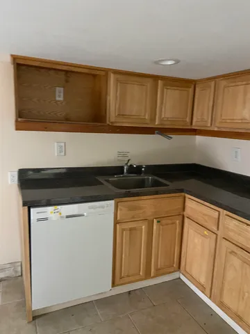 a kitchen with a sink and cabinets