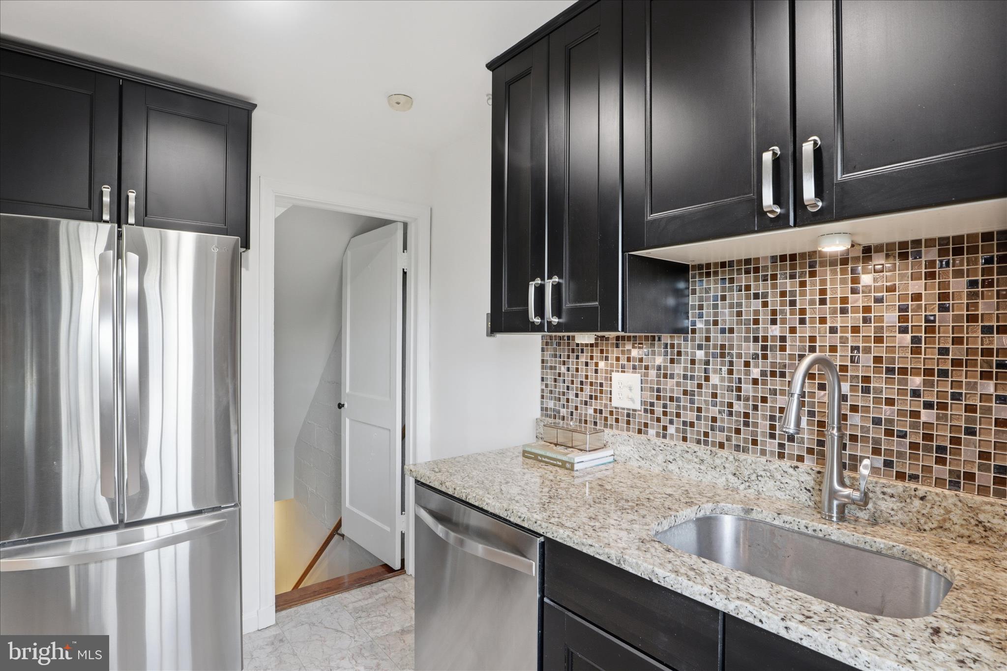 2238 Arlington Terrace Alexandria, VA 22303 - Photo 4 of 37 a bathroom with a granite countertop double vanity sink and mirror