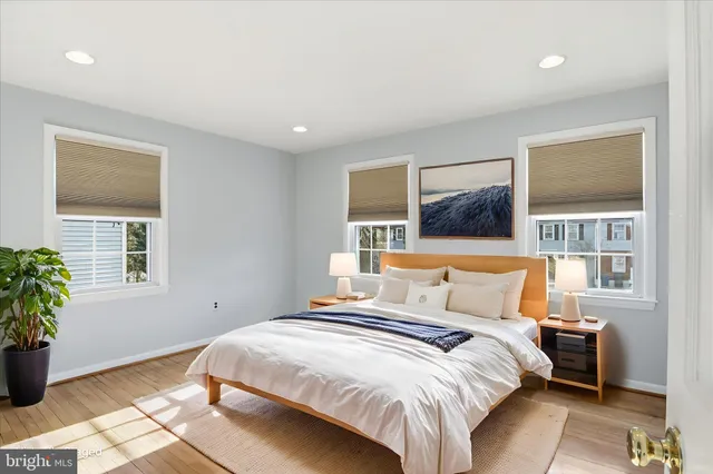 a bedroom with a bed and a potted plant