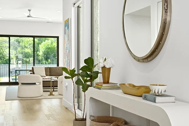 a living room with furniture and a mirror