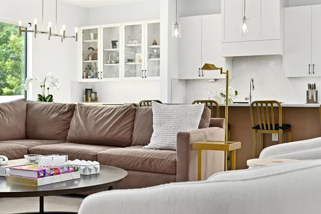 a living room with furniture a flat screen tv and a couch