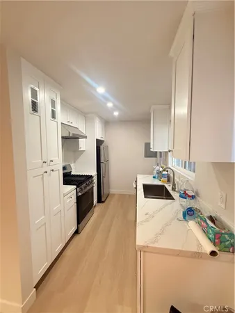 a kitchen with a sink appliances and cabinets