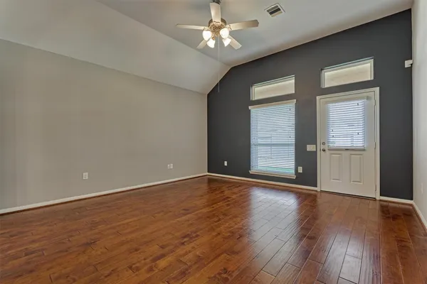 wooden floor in an empty room with a window