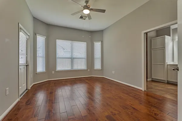wooden floor in an empty room with a window