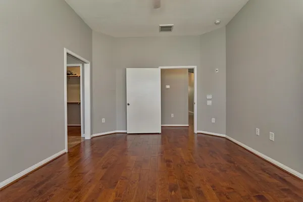 a view of an empty room and wooden floor