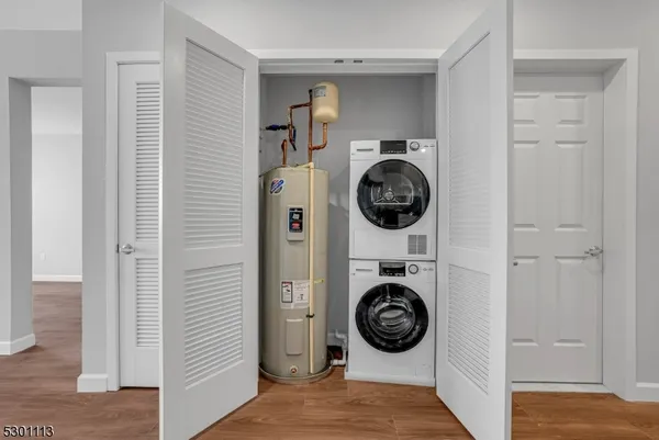 a view of walk in closet with washer and dryer
