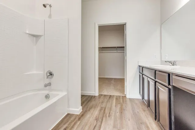 a kitchen with a sink cabinets and a wooden floor
