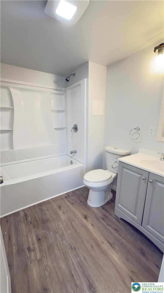 403 North Walnut Street, Unit D Bath, PA 18014 - Photo 8 of 17 a bathroom with a toilet a sink and a bathtub