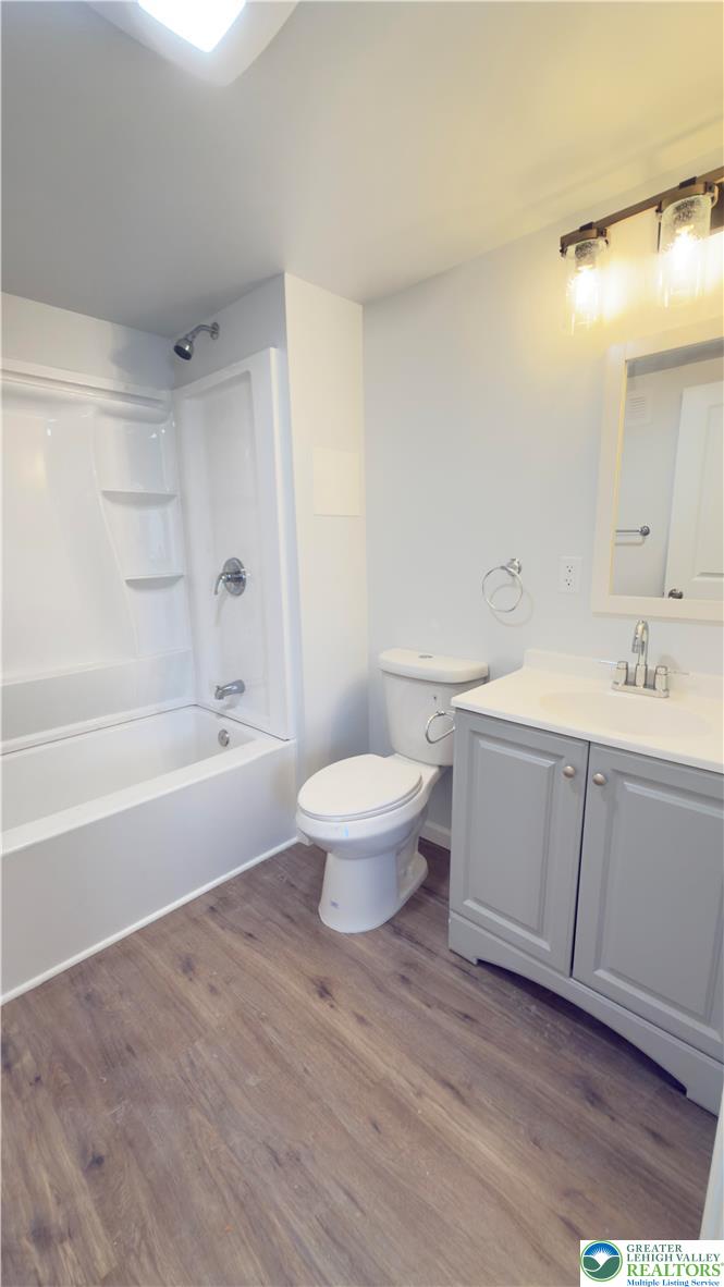 403 North Walnut Street, Unit D Bath, PA 18014 - Photo 9 of 17 a bathroom with a bathtub shower sink mirror and toilet