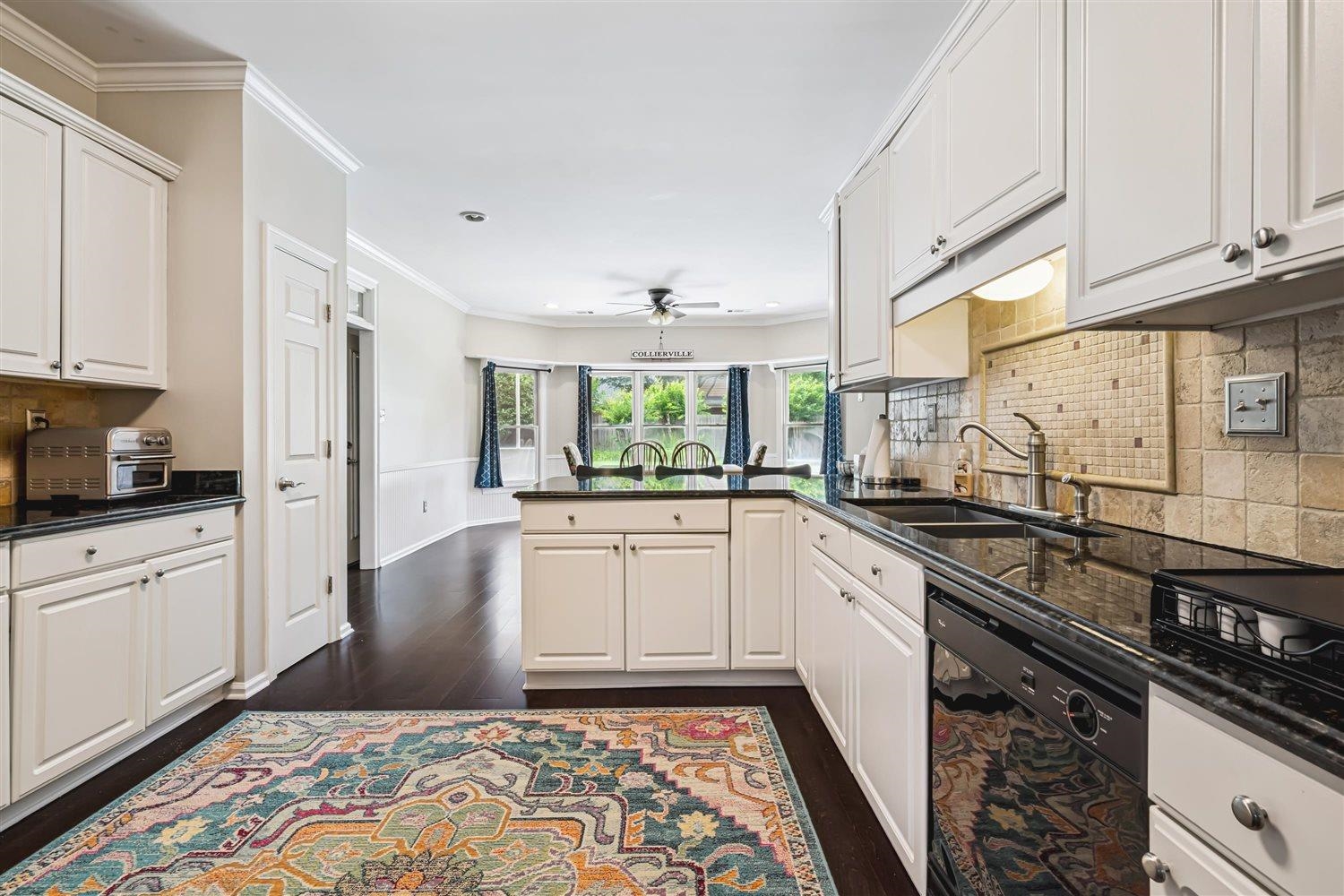1489 John Ridge Drive Collierville, TN 38017 - Photo 19 of 39 a large kitchen with a sink and cabinets