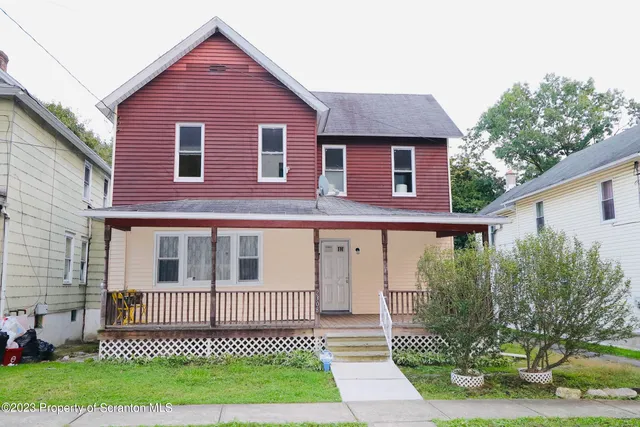 a view of a brick house with a yard