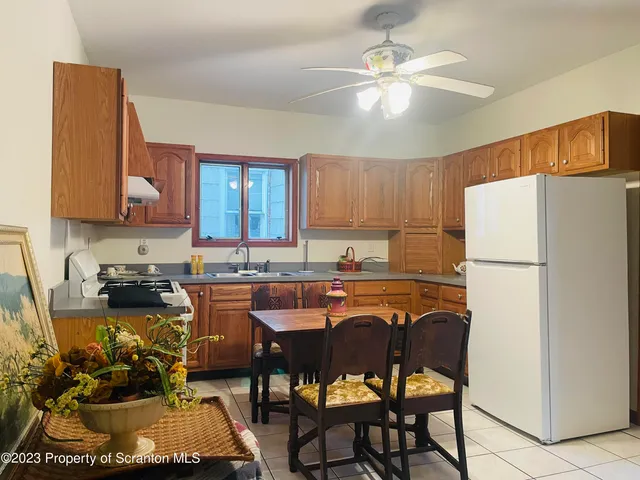 a kitchen with a refrigerator a stove a sink and a cabinets