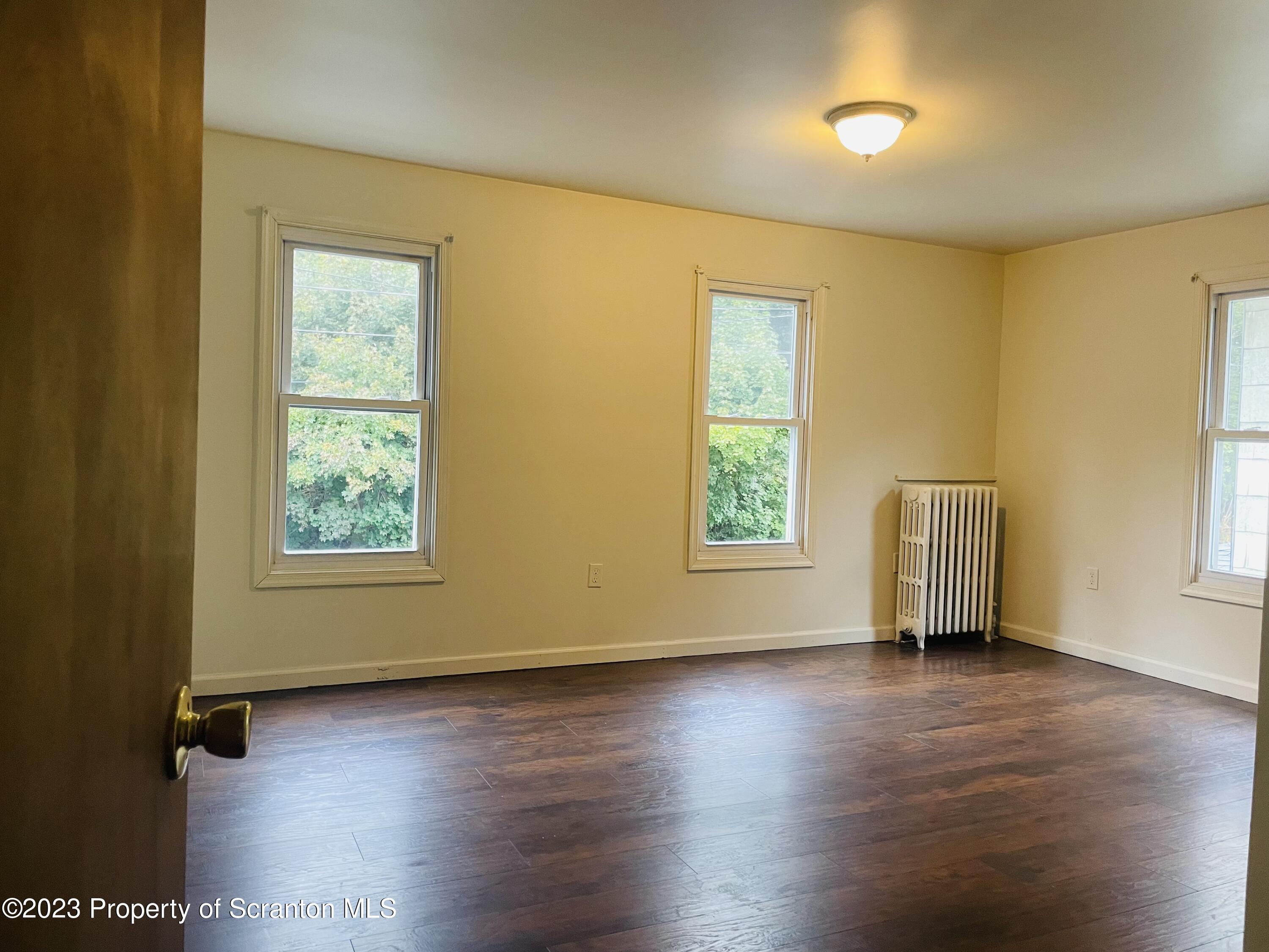2308 Pond Avenue Scranton, PA 18508 - Photo 12 of 26 a view of an empty room with wooden floor and a window