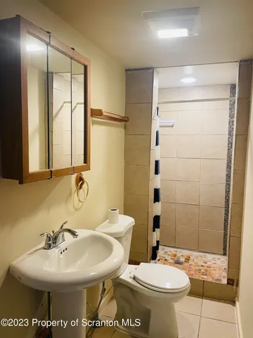 a bathroom with a sink toilet and shower
