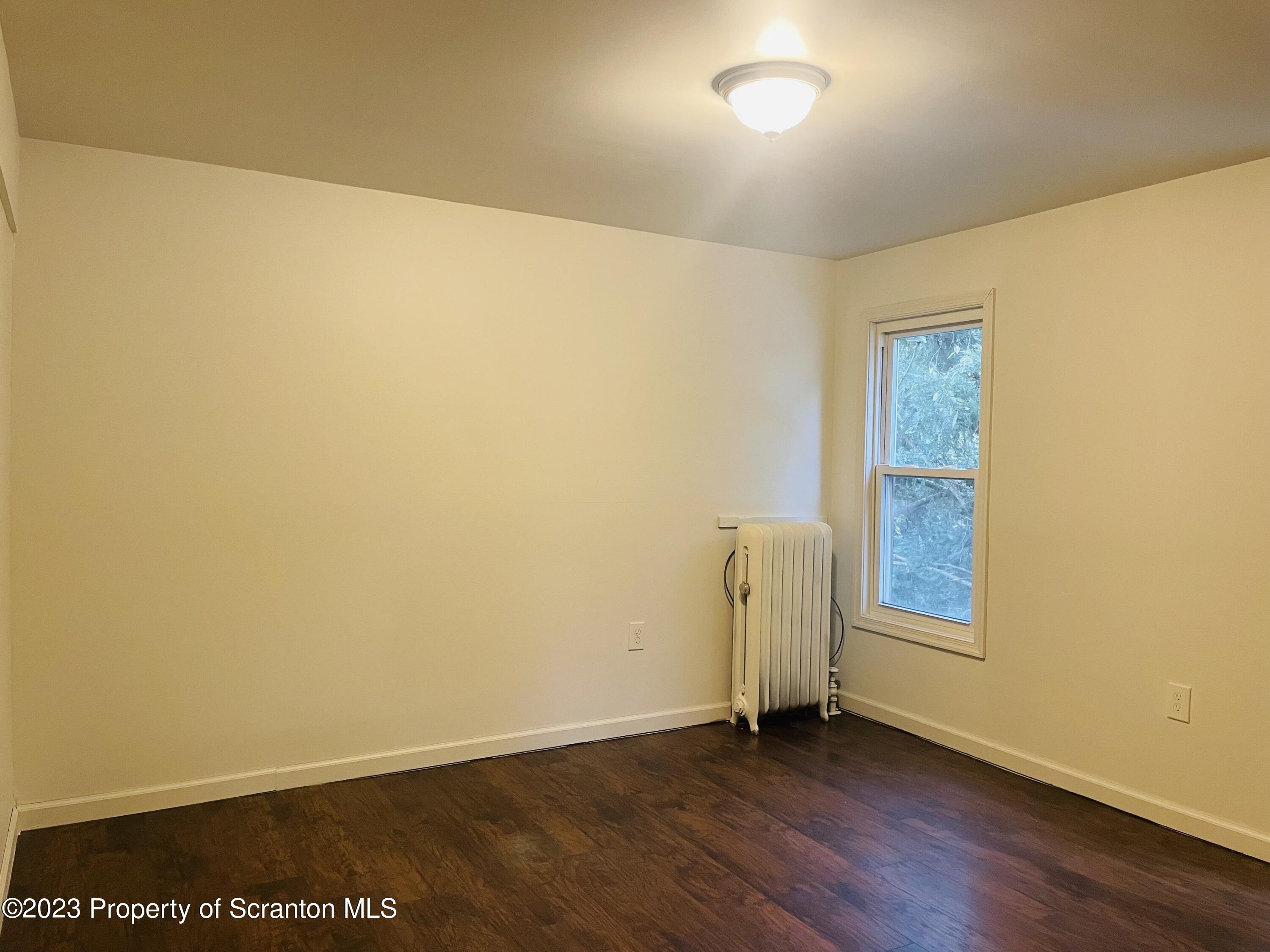 2308 Pond Avenue Scranton, PA 18508 - Photo 17 of 26 an empty room with wooden floor and windows