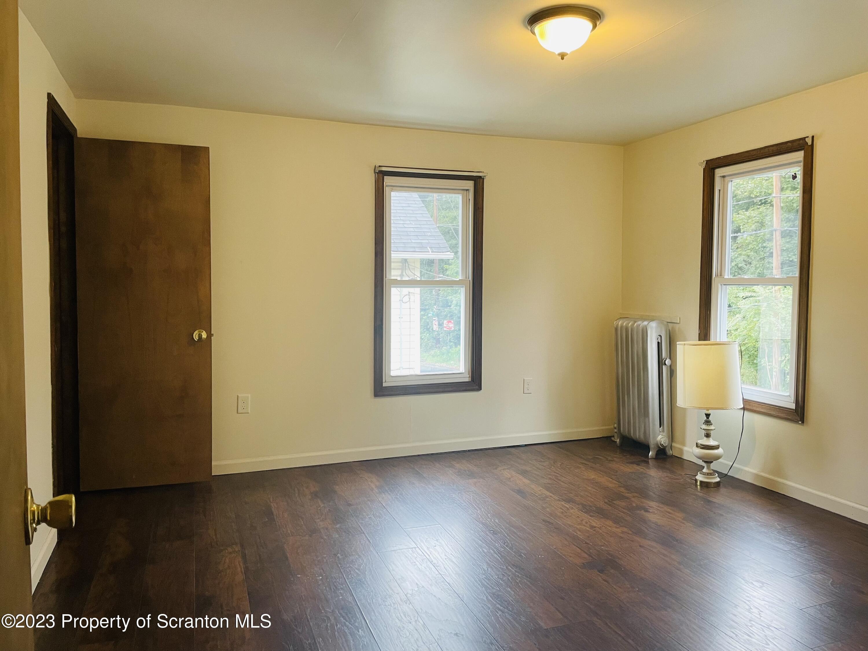 2308 Pond Avenue Scranton, PA 18508 - Photo 20 of 26 an empty room with wooden floor and windows